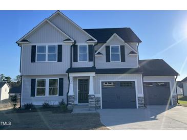 Two-story home with gray siding, black shutters, and a two-car garage at 38 Flatland Dr, Princeton, NC 27569