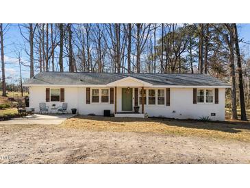 Charming ranch-style home with a brick facade, green door, and inviting front porch at 4775 Barber Mill Rd, Clayton, NC 27520