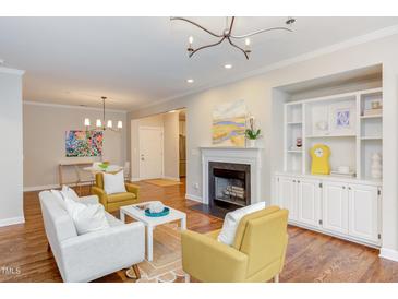 Bright living room featuring a fireplace, built-in shelving, and contemporary furnishings at 604 Copperline Dr # 108, Chapel Hill, NC 27516