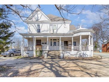 Charming two-story home featuring a classic wrap-around porch and decorative architectural details at 616 N Mebane St, Burlington, NC 27217