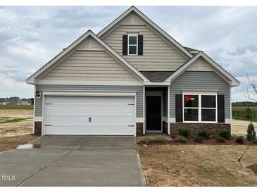 Charming single-Gathering home featuring a two-car garage and craftsman-style architectural details at 72 E Victory View Ter, Smithfield, NC 27577