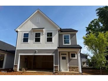 Charming two-story home featuring a modern design, a spacious garage, and a beautifully landscaped yard at 82 Fairwinds Dr, Lillington, NC 27546