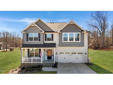 Charming two-story home with a welcoming front porch and a two-car garage at 1318 Reading Ct, Burlington, NC 27217
