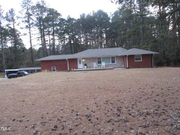 Charming ranch-style home with brick accents, front porch, and a spacious front yard, offering comfortable living at 2506 Poole Rd, Raleigh, NC 27610