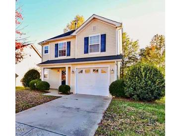 Two story home with a well maintained lawn, a driveway, and an attached garage at 3742 Marshlane Way, Raleigh, NC 27610