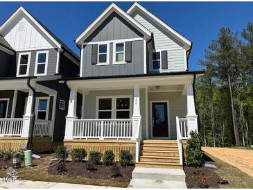 Charming two-story home featuring a welcoming front porch and modern architectural details at 500 Yeowell Dr, Chapel Hill, NC 27514