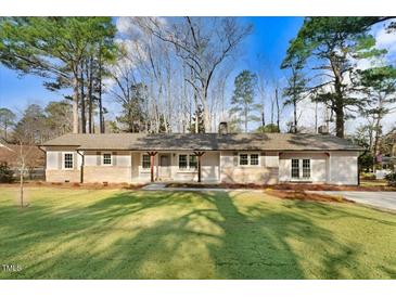 Charming single-story home with a well-manicured lawn and mature trees offering curb appeal at 210 S General Lee Ave, Dunn, NC 28334
