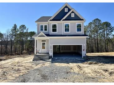 New construction two-story home with blue and gray siding and an attached two-car garage at 394 Duncan Creek Rd # 158, Lillington, NC 27546