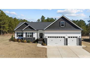 Charming one-story home featuring a three-car garage and a beautifully landscaped front yard at 405 Joseph Alexander Dr, Fuquay Varina, NC 27526