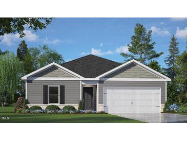 Charming single-story home featuring gray siding, a two-car garage, and beautifully landscaped front yard at 417 Citron St, Sanford, NC 27332