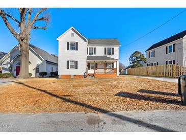 Charming two-story home with classic white siding and a welcoming front porch at 107 N 12Th St, Erwin, NC 28339