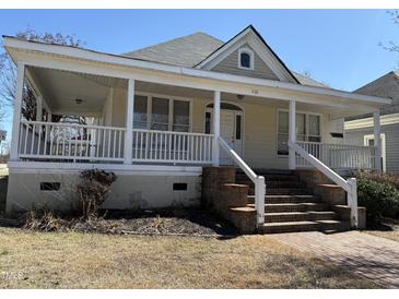 Charming home featuring a welcoming front porch with brick steps and white railings at 1130 N Roxboro St, Durham, NC 27701