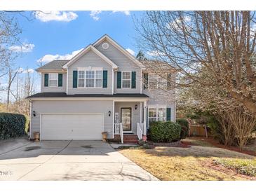 Charming two-story home with gray siding, green shutters, manicured lawn, and inviting front entrance at 1218 Twelve Oaks Ln, Apex, NC 27502