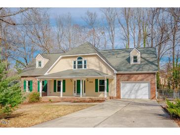 Charming home featuring brick accents, dormer windows, and a welcoming front porch at 1514 Wiljohn Rd, Garner, NC 27529