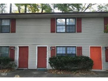 Two-story home featuring red shutters and doors, complemented by light-colored siding at 228 Adams St, Cary, NC 27513