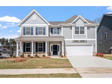 Charming two-story home with gray siding, stone accents, and a well-manicured front yard at 322 N Maple Walk Walk # 237, Garner, NC 27529