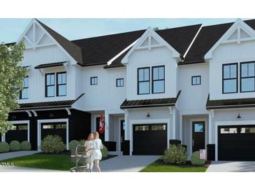 Beautiful new townhomes feature modern design with a white and black color scheme and attached garages at 4093 Elk Crk Ln, Raleigh, NC 27612