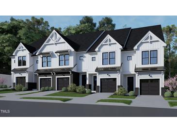 Charming townhomes with white siding, black accents, garage, and landscaping at 4095 Elk Crk Ln, Raleigh, NC 27612