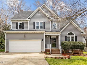 Charming two-story home featuring a gray exterior, attached garage, and well-maintained landscaping at 4745 Grand Cypress Ct, Raleigh, NC 27604