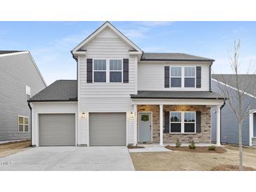 Charming two-story home with a two-car garage and stone accents at 55 Mable Court # 5, Lillington, NC 27546