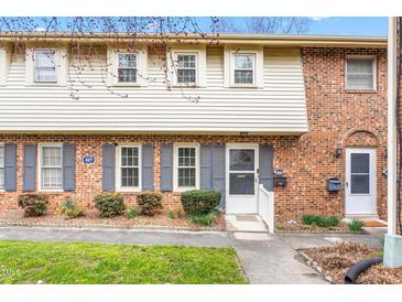 Charming brick townhome with blue shutters, tidy landscaping, and a welcoming entrance at 627 W Front St # C, Burlington, NC 27215