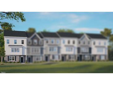 Charming townhouse with classic white facade, stone accents, and well-manicured lawn at 813 Washington St, Fuquay Varina, NC 27526