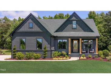 Charming modern farmhouse with a dark exterior, well-manicured lawn, and inviting front porch at 0 High Rock Rd, Efland, NC 27243
