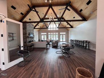 Spacious clubhouse featuring vaulted wood ceilings, a stone fireplace, seating, and abundant natural light at 270 Inspiration Way Way, Fuquay Varina, NC 27526