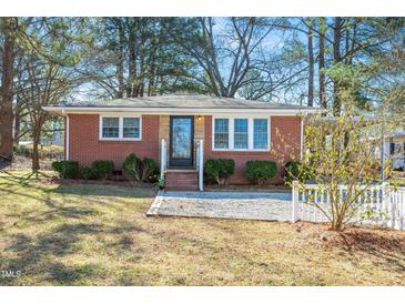 Charming brick home with a well-maintained lawn and inviting front porch at 326 Lake Dr, Wendell, NC 27591