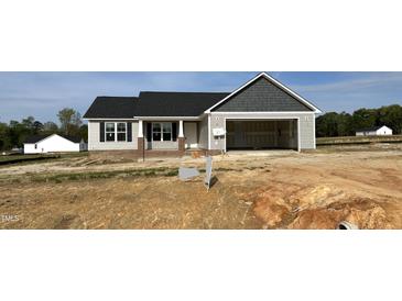 Charming single Gathering home with a two-car garage and covered entry in a new construction neighborhood at 39 N Movado Trl, Kenly, NC 27542