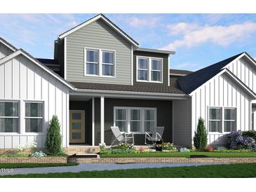 Charming two-story home with a welcoming front porch and well-manicured landscaping at 3930 Willow Gate Way, Raleigh, NC 27604