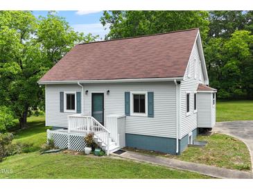 Charming home featuring a well-maintained yard, fresh paint, and a welcoming front porch at 524 N Occoneechee St, Hillsborough, NC 27278