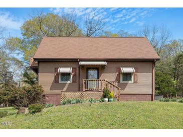 Charming single-story home with a well-maintained lawn and cozy front porch at 524 N Occoneechee St, Hillsborough, NC 27278