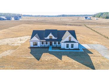 Gorgeous new construction home featuring a welcoming front porch and ample land for privacy at 525 Sanctuary Trl, Cameron, NC 28326