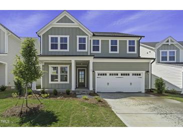 Charming two-story home with gray siding, a two-car garage, and a well-maintained lawn at 63 Daybreak Way, Fuquay Varina, NC 27526