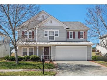 Charming two-story home with a well-maintained lawn, inviting curb appeal, and attached garage at 634 Conover Rd, Durham, NC 27703