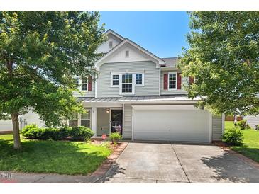 Charming two-story home with attached two-car garage, well-maintained lawn, and mature trees at 634 Conover Rd, Durham, NC 27703