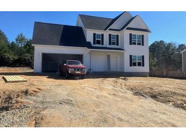 Charming two-story home with a two-car garage and a red truck in the driveway at 81 Reece Dr, Sanford, NC 27332
