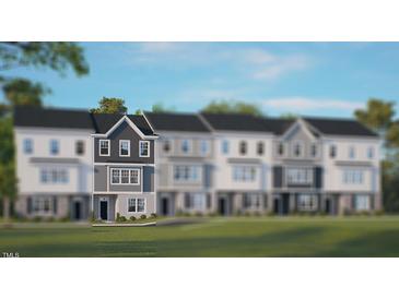 Charming townhome with a modern design and well-manicured lawn, showcasing curb appeal at 821 Washington St, Fuquay Varina, NC 27526