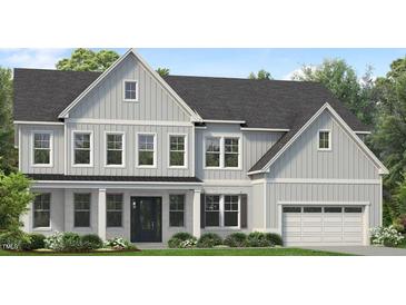 Charming two-story home with a combination of white brick and vertical siding with a dark roof and black front door at 828 Timber Mist Ct, Cary, NC 27519