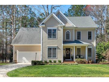 Two-story home featuring a two-car garage, a gabled roof, and a well-maintained front lawn at 104 Musgrove Cir, Cary, NC 27518