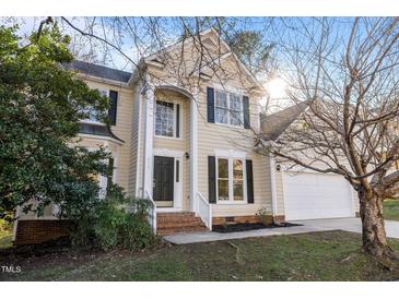 Charming two-story home featuring a classic design, well-manicured lawn, and a welcoming entrance at 215 Longbridge Dr, Cary, NC 27518