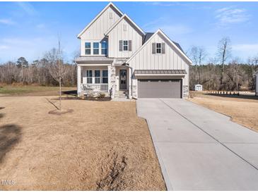 Charming two-story home with a gray trim and stone accents at 285 Scotland Dr, Youngsville, NC 27596