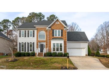 Traditional two-story brick and siding home with well-manicured landscaping and a two-car garage at 3528 Dewing Dr, Raleigh, NC 27616