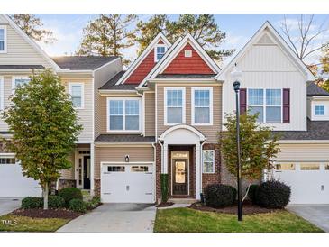 Charming townhome with a brick facade, attached garage, and well-manicured landscaping at 357 Roberts Ridge Dr, Cary, NC 27513