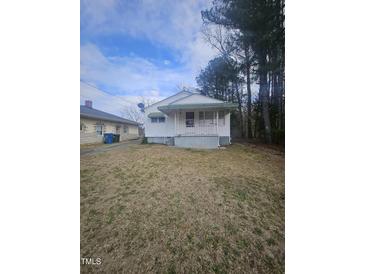 Charming single-story home with a quaint front porch and lawn at 4805 Barbee Rd, Durham, NC 27713