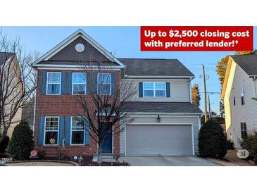 Charming two-story home featuring a brick facade, blue shutters, and an attached two-car garage at 508 Stapleford Ln, Fuquay Varina, NC 27526