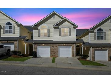 Charming townhome with brick accents, private garage, and welcoming curb appeal at 1306 Plexor Ln, Knightdale, NC 27545