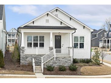 Charming single-story home with white siding, a stone foundation, and a welcoming front porch at 1737 Fence Post Rd, Wendell, NC 27591