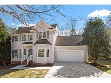 Charming two-story home with attached two-car garage, bay window and a well-manicured front yard at 205 Caniff Ln, Cary, NC 27519